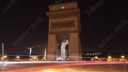Long exposure in Paris Arc de Triomphe (Triumphal Arch) in Chaps Elysees at sunset, Paris, France. Architecture and landmarks of Paris. Postcard of Paris