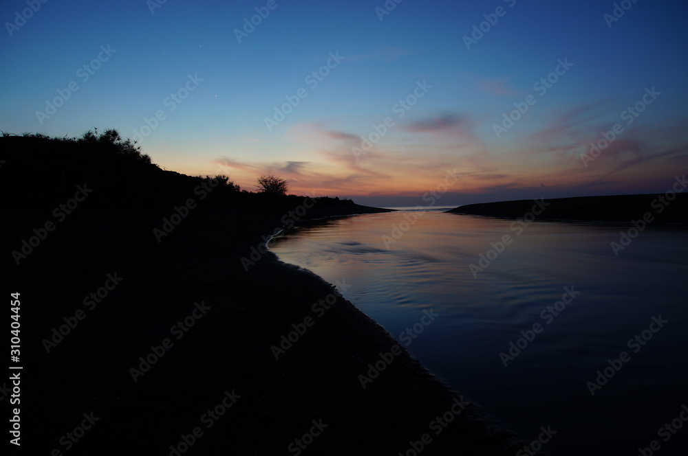 Fototapeta premium sunset and sunrise are natural beauty at the end of the night and dusk gives perfect color to the sky so the clouds look beautiful to be seen with a beach background.
