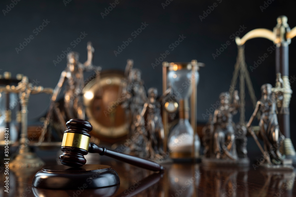 Law theme. Gavel of the judge, Themis statue and scale of justice on gray background. Law theme. Gavel of the judge, Themis statue and scale of justice on gray background.