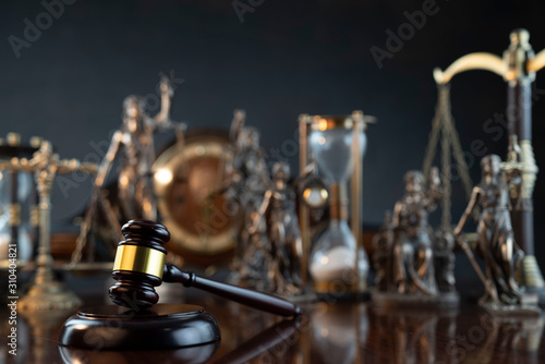 Law theme. Gavel of the judge, Themis statue and scale of justice on gray background.