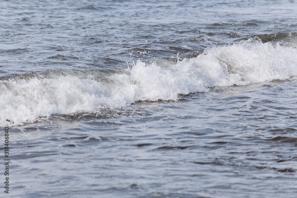 Fototapeta premium Waves on the beach. A surge of water ashore.