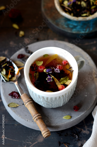Berry flower tea on a dark wooden background
