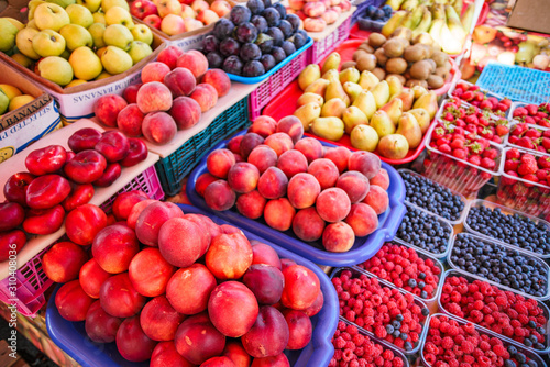Fototapeta Naklejka Na Ścianę i Meble -  Fresh, juicy fruits at a market under the open sky