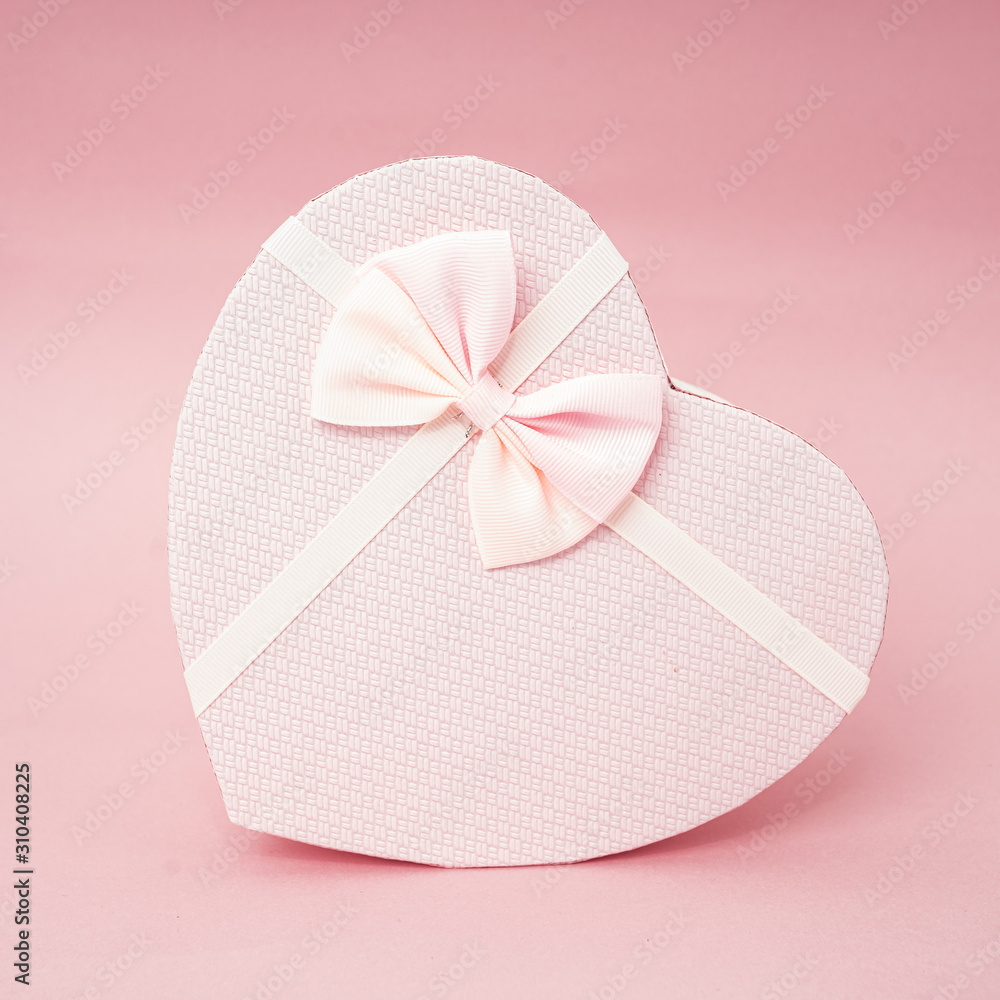 Heart shape gift box on a pink background Heart shape gift box on a pink background
