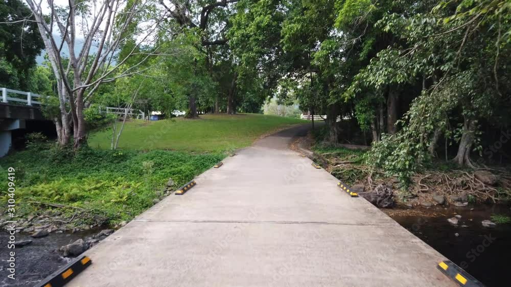 walking accross a walking bridge Over a creek walking accross a walking bridge Over a creek