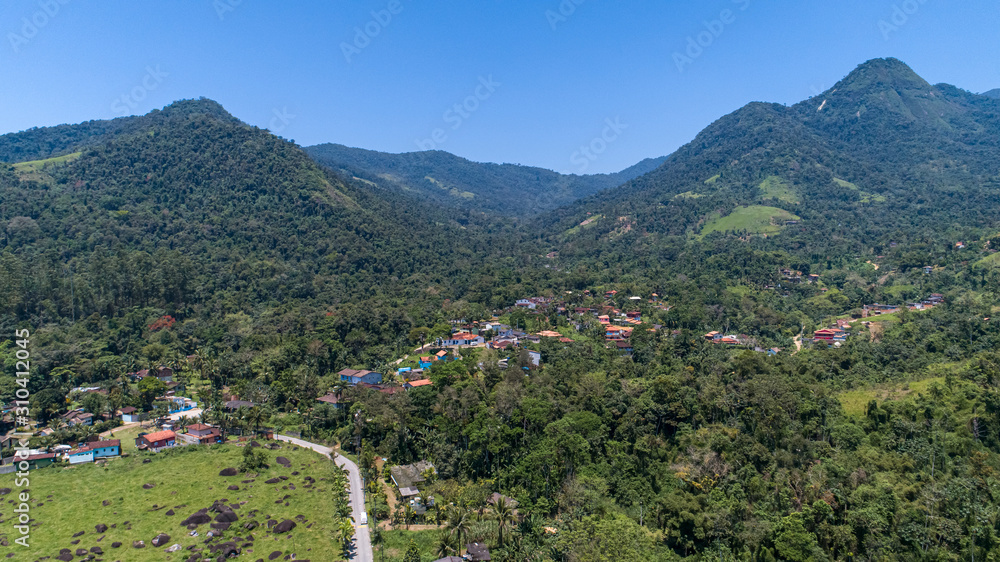 Aerial view to the mountaineous green hinterland of Tarituba on a sunny day, Green coast, Brazil