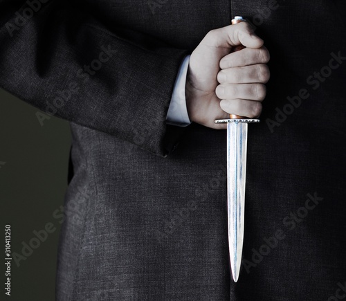 Midsection Of Businessman Holding Knife photo