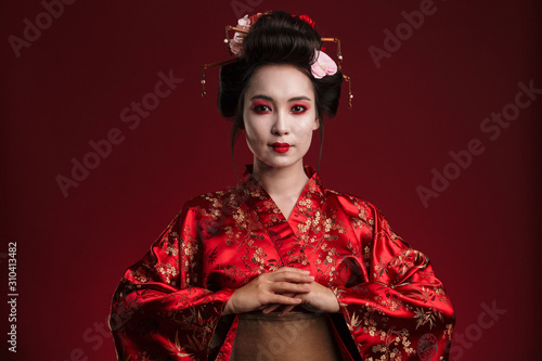 Fototapeta Image of beautiful young geisha woman in traditional japanese kimono