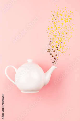 Creative shot of star shape confetti pouring from tea pot.