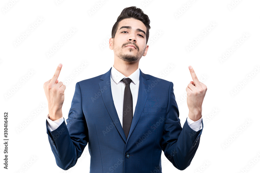 Young man in a blue suit showing middle fingers on a white background. Isolated. Young man in a blue suit showing middle fingers on a white background. Isolated.