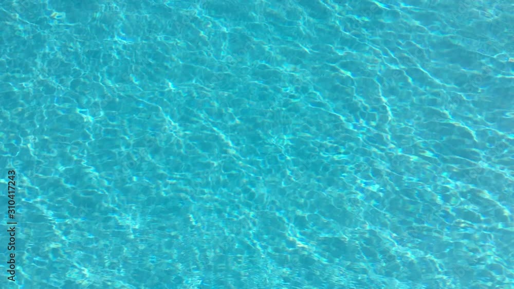 Swimming pool water in a luxury resort on a sunny summer day. Summer vacation Swimming pool water in a luxury resort on a sunny summer day. Summer vacation