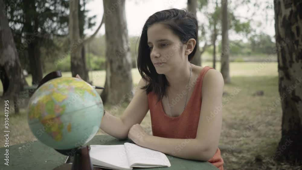 Girl Traveller Searching on World Globe and Taking Note Girl Traveller Searching on World Globe and Taking Note