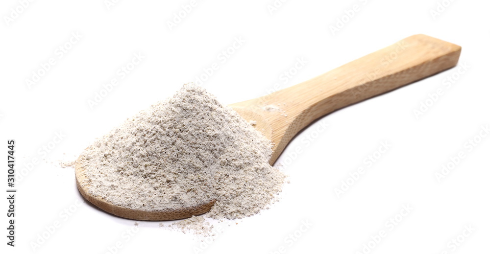 Buckwheat integral flour pile with wooden spoon isolated on white background Buckwheat integral flour pile with wooden spoon isolated on white background
