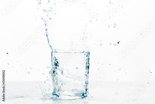 Refreshing liquid splashing into a glass 
