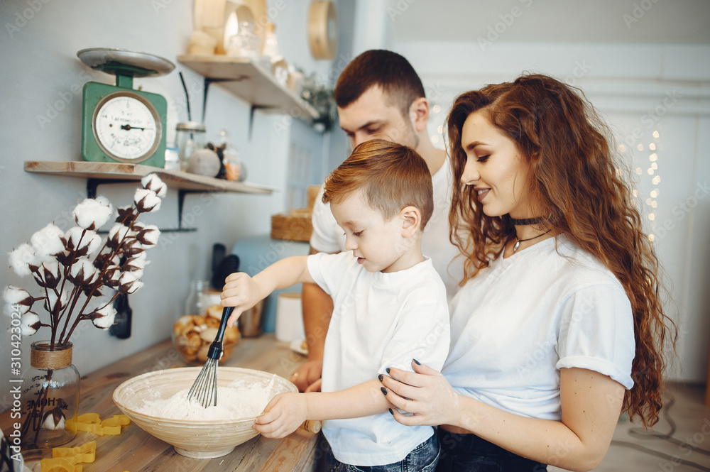 Family is preparing food at home. Little boy in a kitchen Family is preparing food at home. Little boy in a kitchen