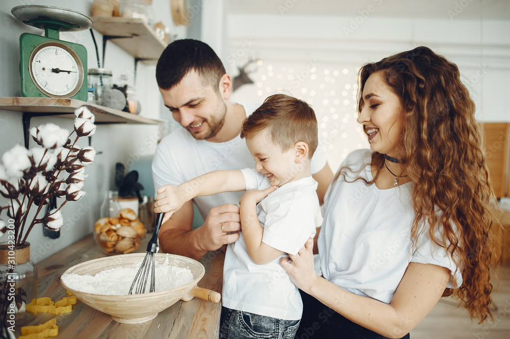 Family is preparing food at home. Little boy in a kitchen Family is preparing food at home. Little boy in a kitchen