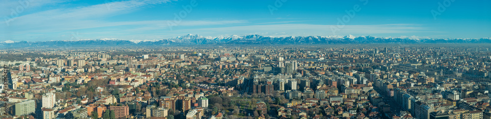 Aerial view of Milan (Italy) with the Lombard Alps in the background
