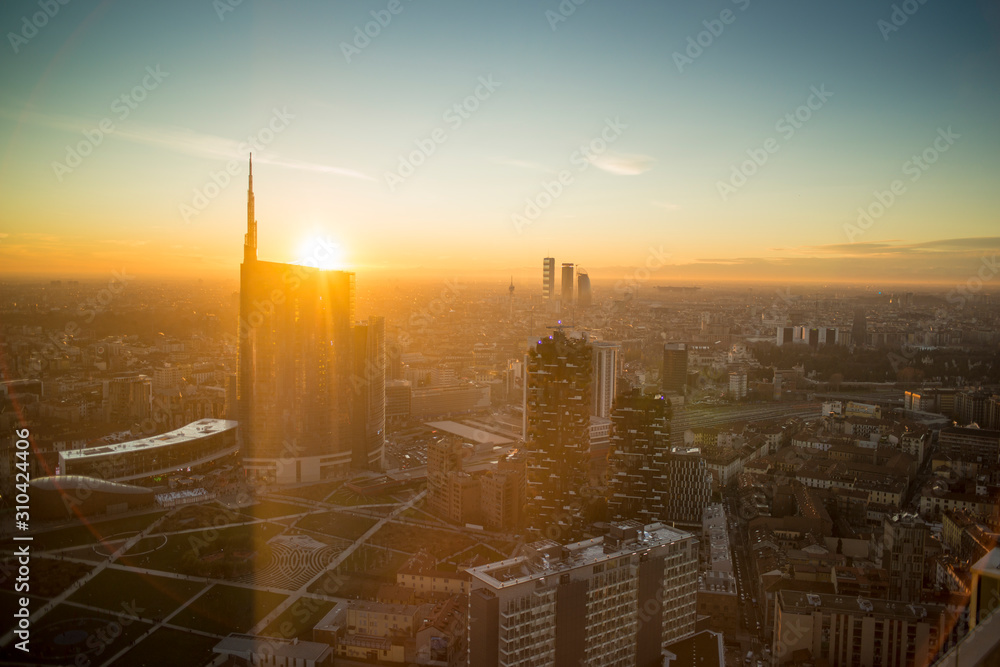 Fototapeta premium Milan cityscape at sunset, panoramic view with new skyscrapers in Porta Nuova district. Italian landscape.