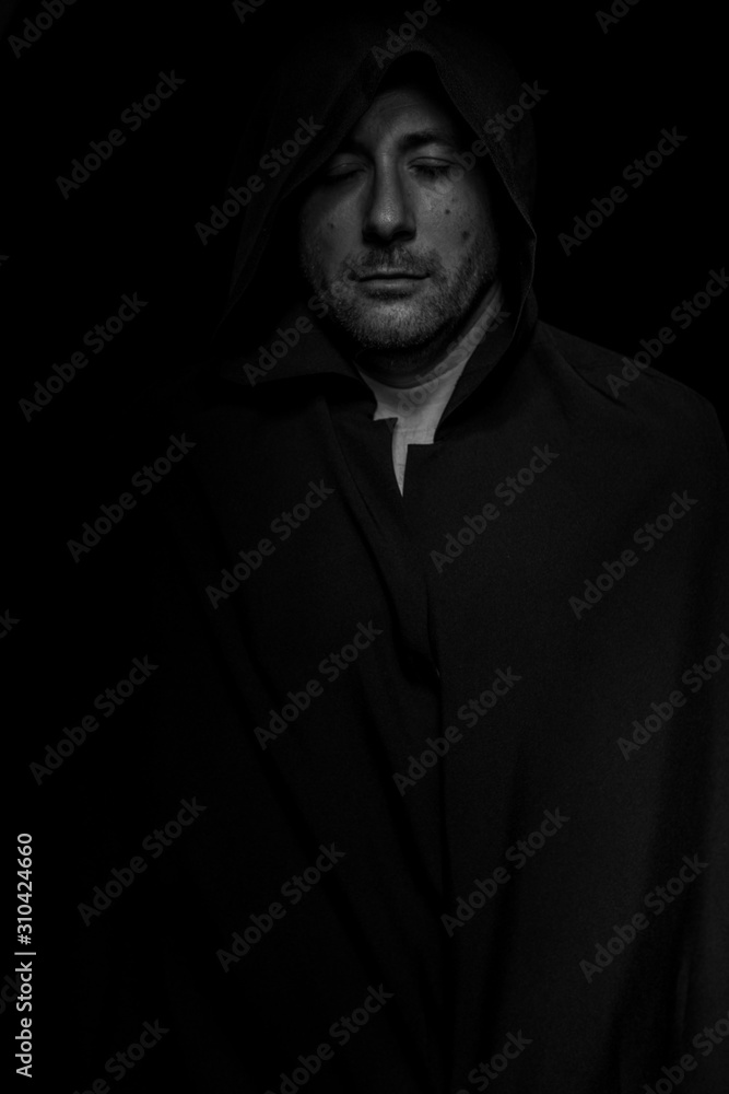 Portrait of a courageous warrior wanderer in a black cloak. Historical fantasy. Halloween Portrait of a courageous warrior wanderer in a black cloak. Historical fantasy. Halloween