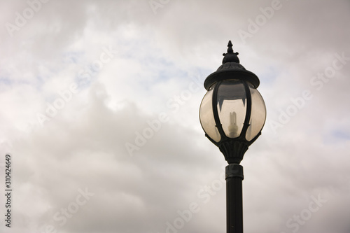 lamp post,Decorative street lamp-post,Retro street lamp shining at night against cloudy sky,Round lamp on pole, outdoor lighting on clear blue sky,street lamp.