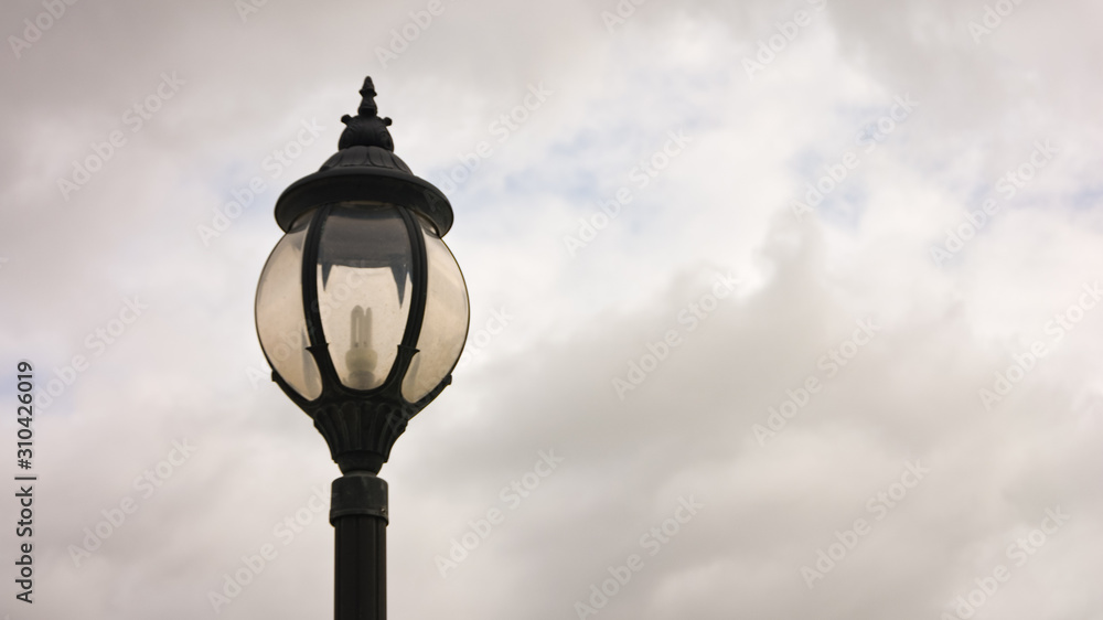 lamp post,Decorative street lamp-post,Retro street lamp shining at night against cloudy sky,Round lamp on pole, outdoor lighting on clear blue sky,street lamp.