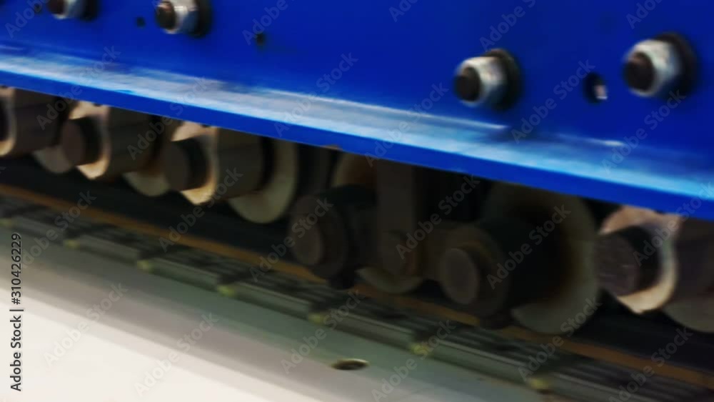 manufacturing industry. modern woodworking machine.technological process.working conveyor along which the blank of the furniture panel moves. fragment of work items and parts close-up manufacturing industry. modern woodworking machine.technological process.working conveyor along which the blank of the furniture panel moves. fragment of work items and parts close-up