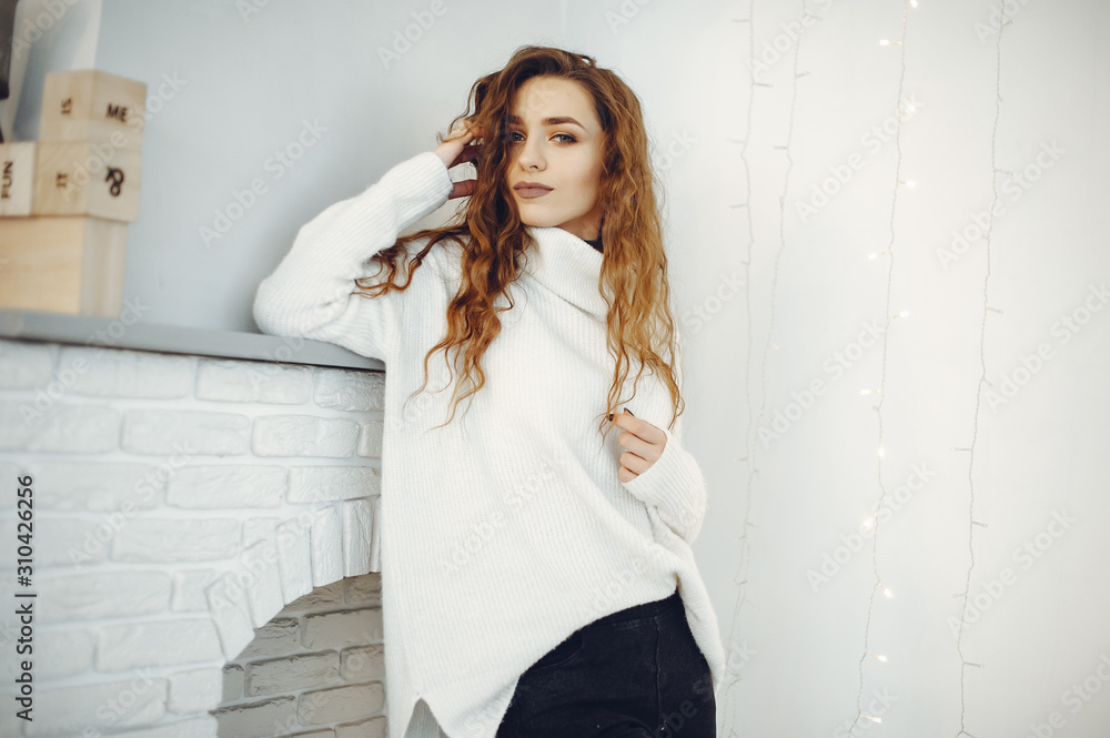 Beautiful girl at home. Lady in a warm sweater Beautiful girl at home. Lady in a warm sweater