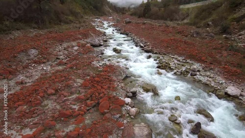 Drone footage of running river through Redstone park close to Moxizhen town in Sichuan, China  photo