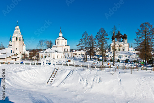 Church of the Resurrection (1680) and Assumption Church (1775) with a bell tower in the form of a pencil in the village Luh/ Ivanovo region/ Russia/ Winter landscape