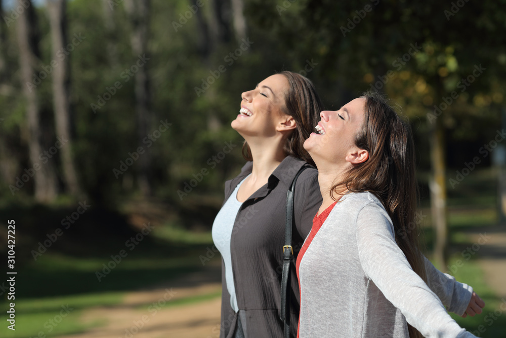 Two happy friends breathing fresh air together