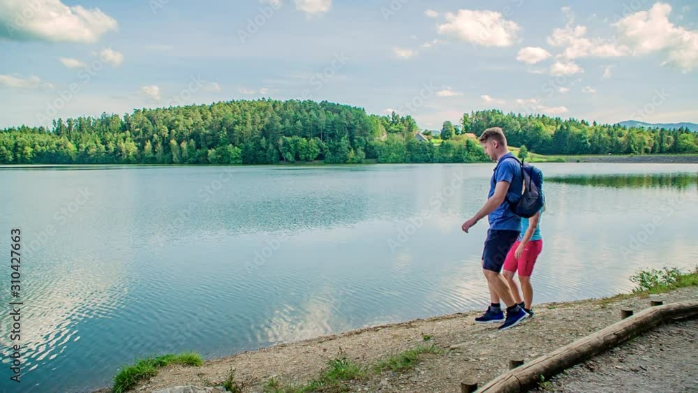 Romantic couple sightseeing panorama of Smartinsko lake, slow motion Romantic couple sightseeing panorama of Smartinsko lake, slow motion