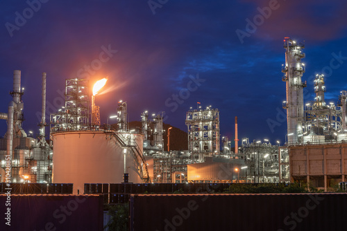 Landscape of Oil and Gas Refinery Manufacturing Plant., Petrochemical or Chemical Distillation Process Buildings., Factory of Power and Energy Industrial at Twilight Sunset., Engineering Petroleum.