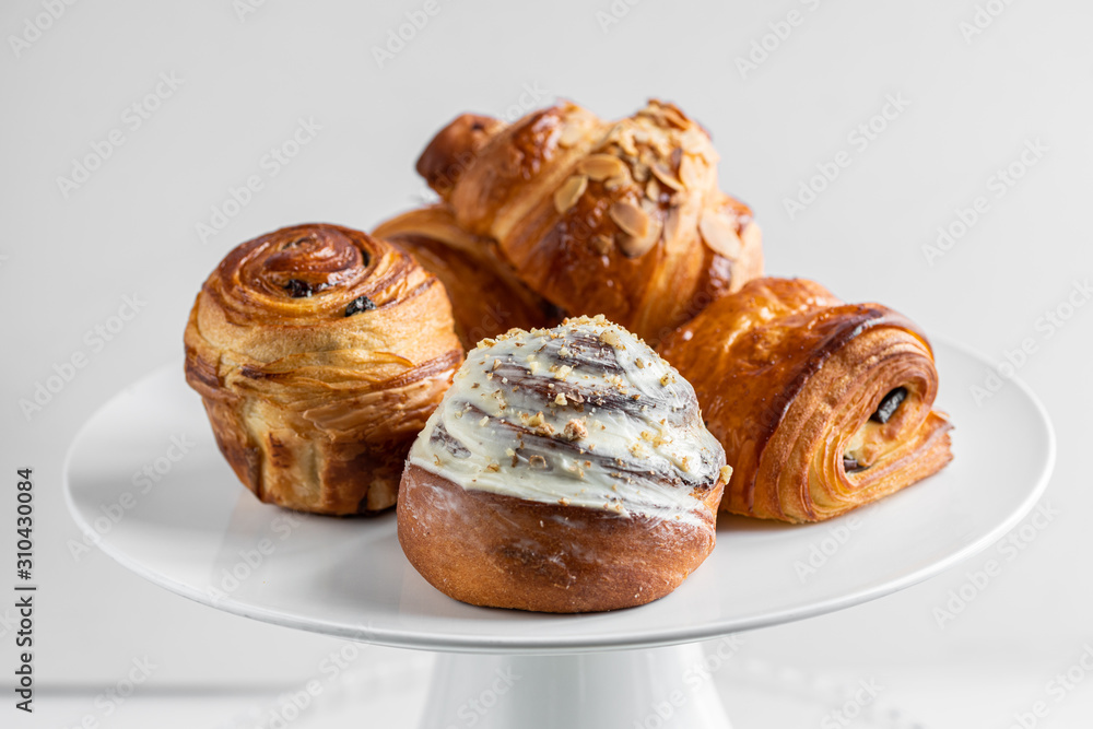 croissants and buns on a white plate