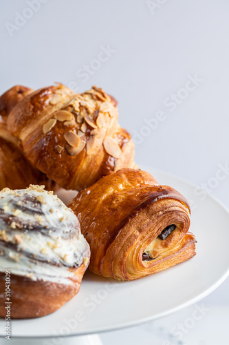 croissants and buns on a white plate
