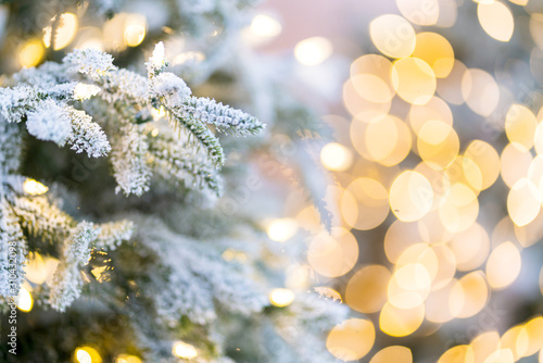 close up christmas tree with snow and light decorating with blur bokeh background photo