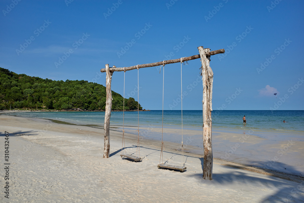 Phu Quoc island, Vietnam - March 27, 2019: Swaying palm tree on Sao beach, one of the most beautiful tropical sandy beaches in Phu Quoc Phu Quoc island, Vietnam - March 27, 2019: Swaying palm tree on Sao beach, one of the most beautiful tropical sandy beaches in Phu Quoc