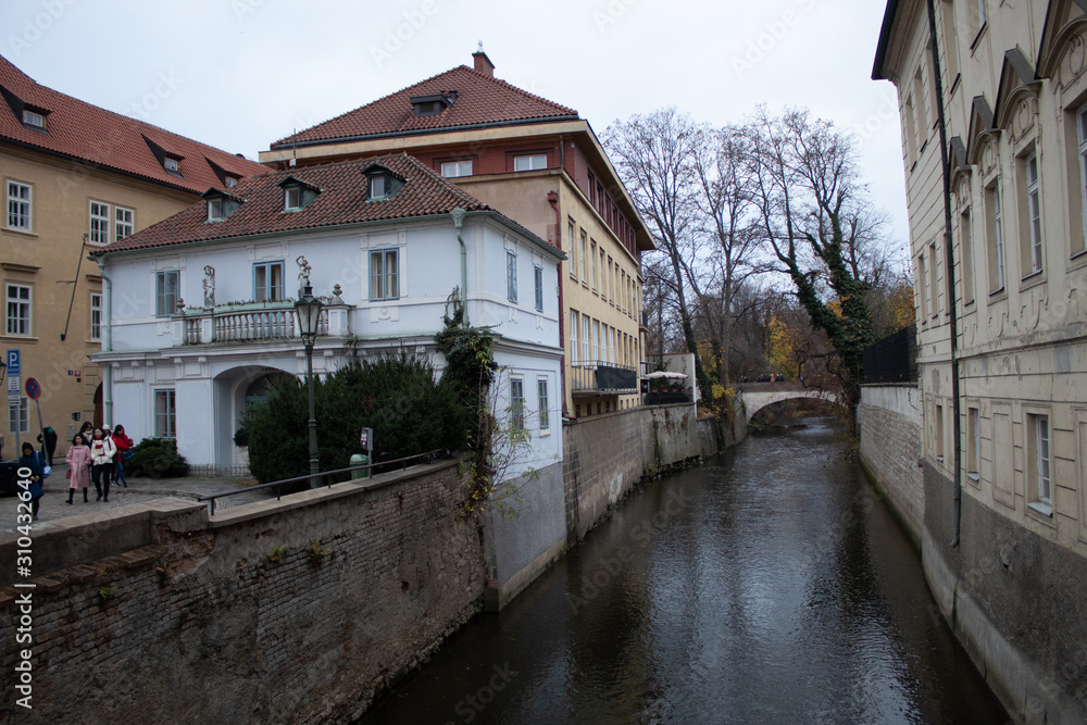 Romantic Prague Venice on the Kampa island in the city of Prague - the Chertovka river with a water mill, cafes and houses along the river.