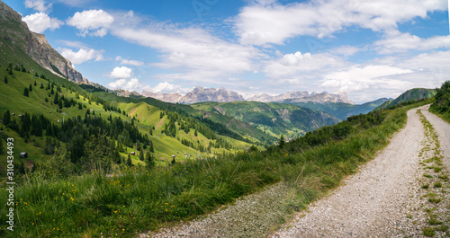 High top mountain dirt road, mountains on background, off road, beautiful view, danger road in mountains, extreme. Passo Pordoi, Italy