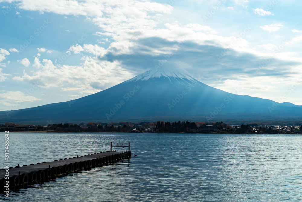 Mountain Fuji in the cloudy day with reflection in the water. Kawaguchiko lake area - Yamanashi, Japan.