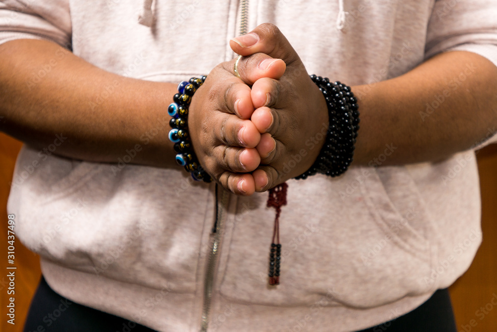 Prayer beads for meditation in woman's hands. Peace and prayer. Awareness and mindfulness