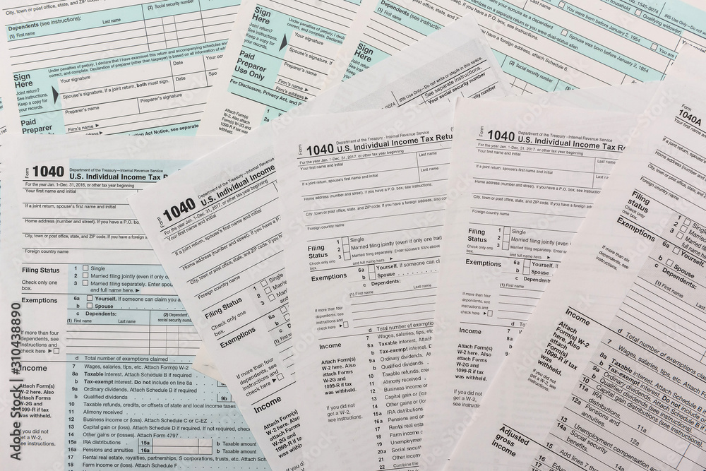 Obraz premium many 1040 tax form. Tax concept.