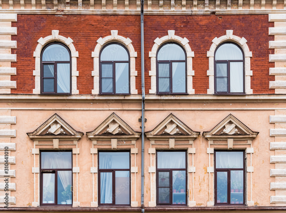 Several windows in a row on the facade of the urban historic building front view, Vyborg, Leningrad Oblast, Russia