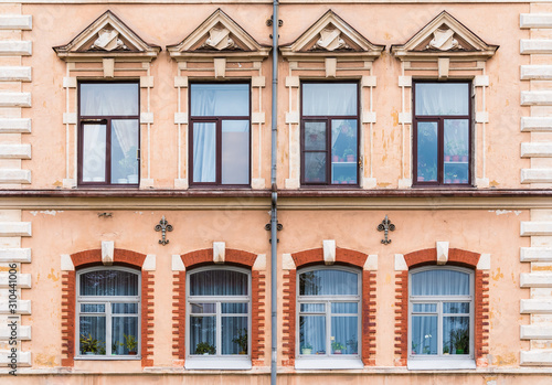 Several windows in a row on the facade of the urban historic building front view, Vyborg, Leningrad Oblast, Russia