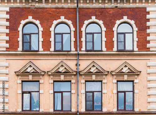 Several windows in a row on the facade of the urban historic building front view, Vyborg, Leningrad Oblast, Russia