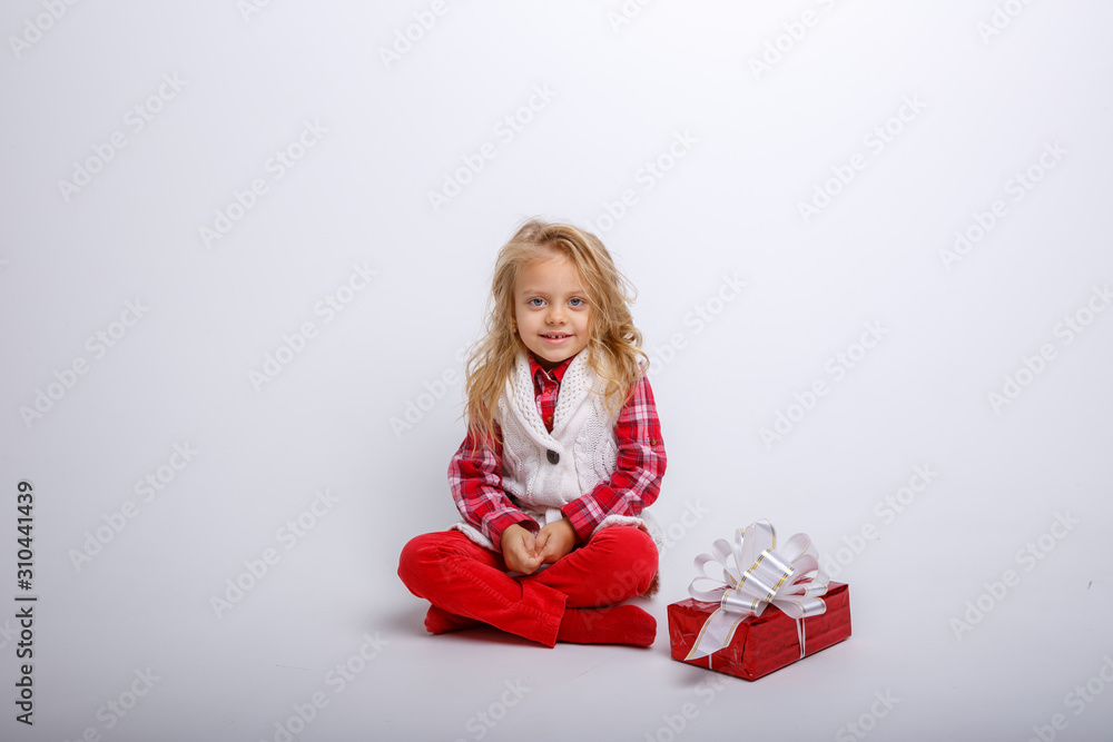 little girl with gift box sitting on white background isolated on white background little girl with gift box sitting on white background isolated on white background
