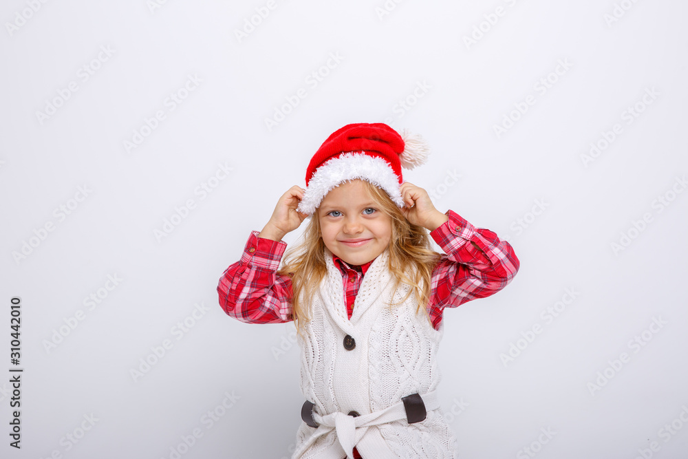 cute happy little girl in santa claus hat. Santa's assistant smiles on a white background cute happy little girl in santa claus hat. Santa's assistant smiles on a white background