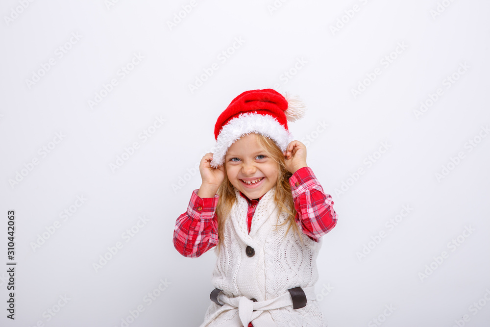 cute happy little girl in santa claus hat. Santa's assistant smiles on a white background cute happy little girl in santa claus hat. Santa's assistant smiles on a white background