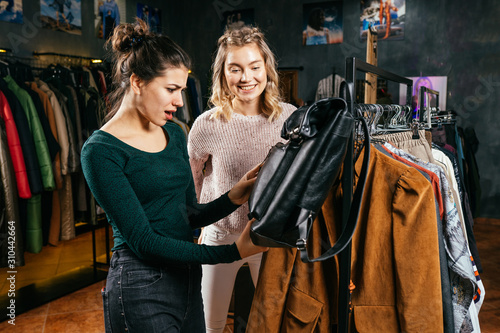 social media influencer at work. blogger explaining style basics. woman holding a stripy top in front of a camera. hobby turned into lucrative business.