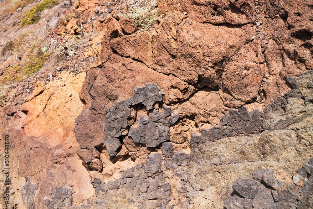 Colored geological layers in the volcanic rock of Madeira Island (Portugal, Europe) Colored geological layers in the volcanic rock of Madeira Island (Portugal, Europe)