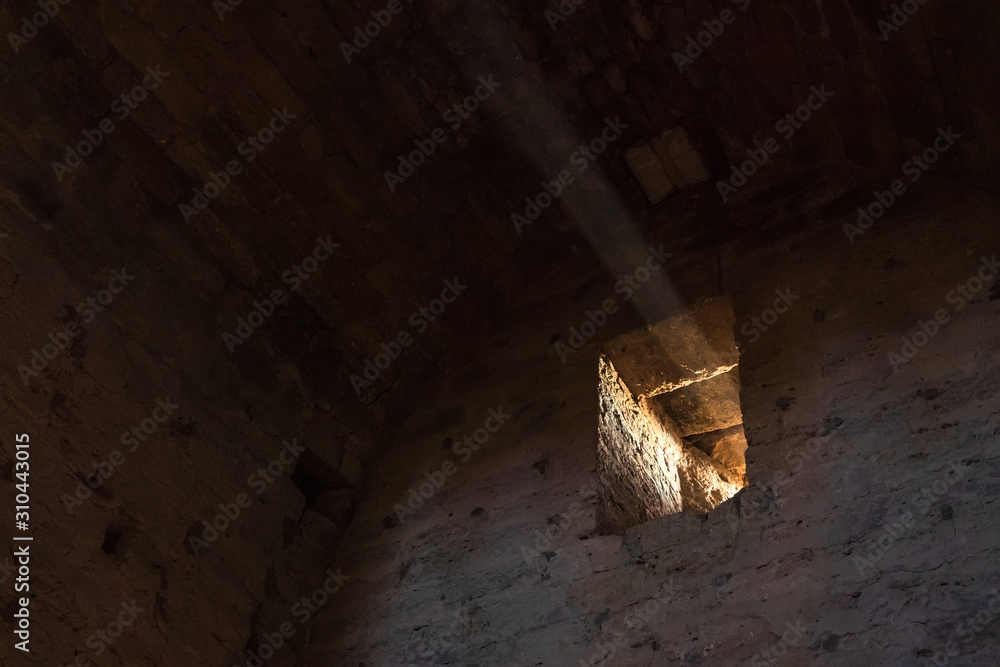 Ray of light in the window of a old stone fortress Ray of light in the window of a old stone fortress
